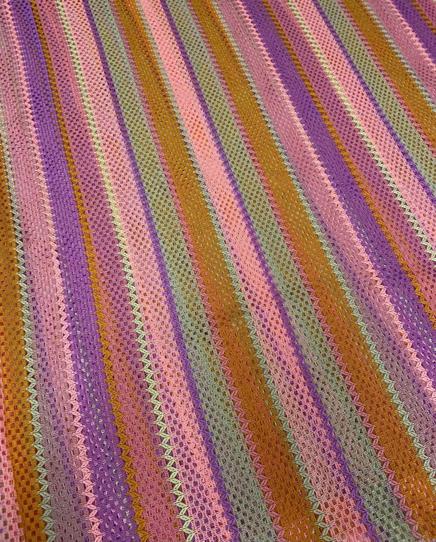 Pink striped knit mesh fabric with breathable texture and colorful vertical stripes for fashion and crafts