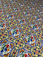 Ceramic design upholstery fabric with colorful floral tile pattern in blue, orange, green, and red on polyester material