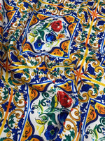 Ceramic design upholstery fabric with vibrant floral and ornamental patterns on durable polyester textile