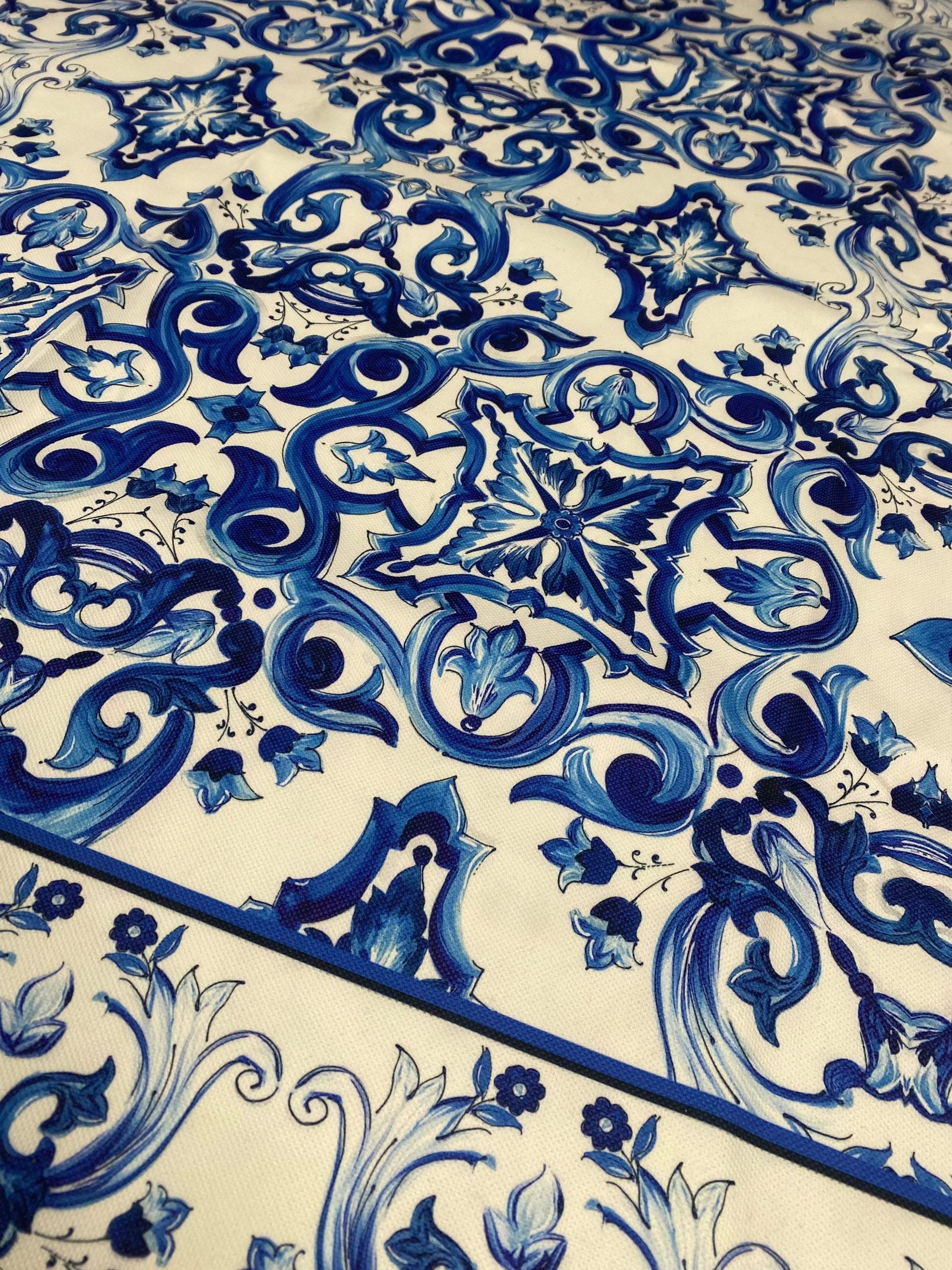 Mojalica Design Upholstery Fabric with intricate blue floral and geometric patterns on cream polyester material