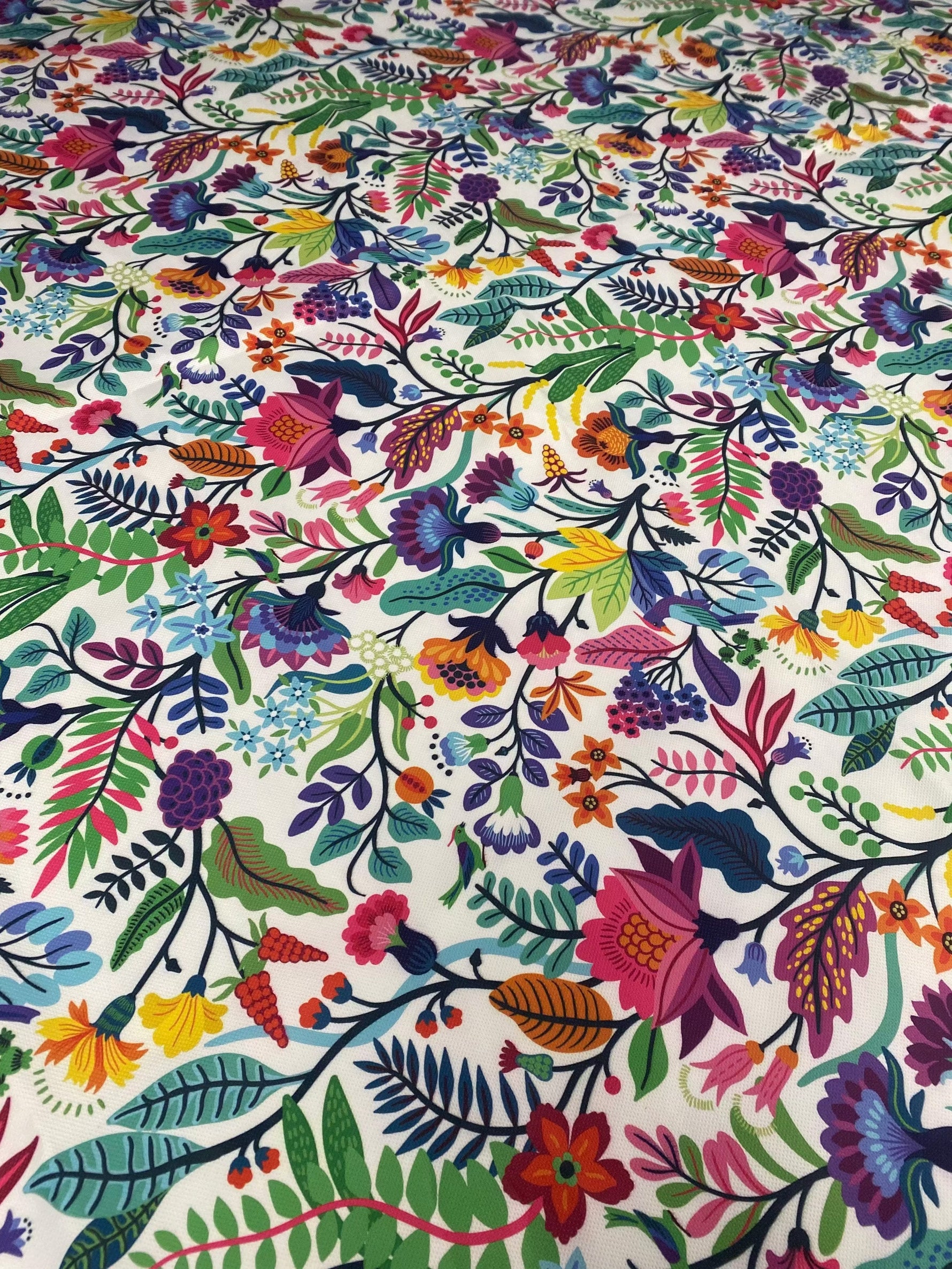colorful floral design upholstery fabric with vibrant flowers and leaves pattern on white background
