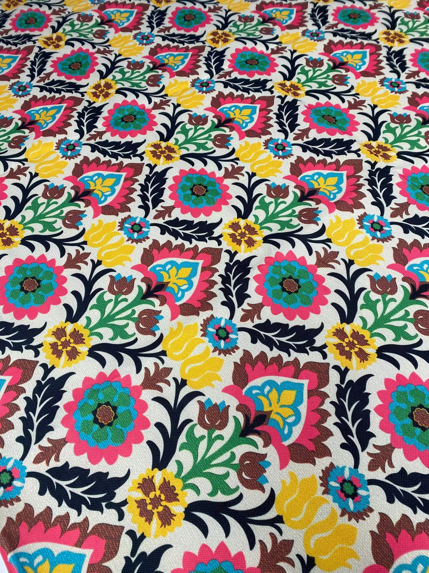 Colorful floral upholstery fabric with vibrant blossoms and intricate patterns for home décor and crafts