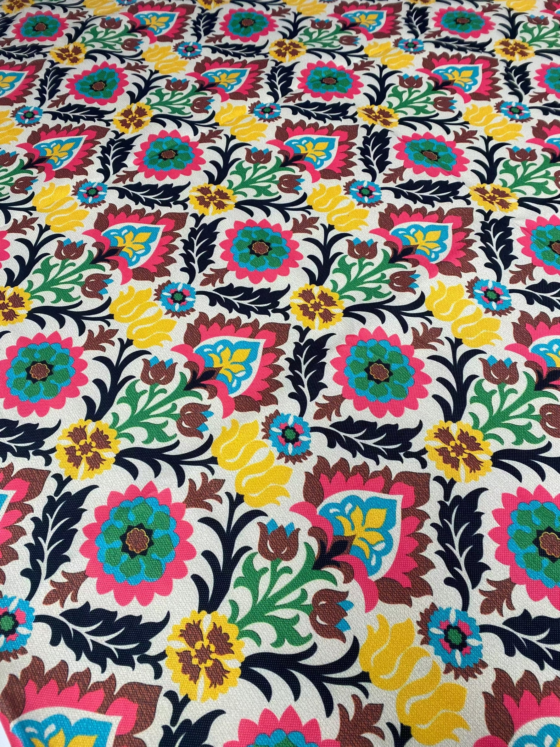 Colorful floral upholstery fabric with vibrant blossoms and intricate patterns for home décor and crafts