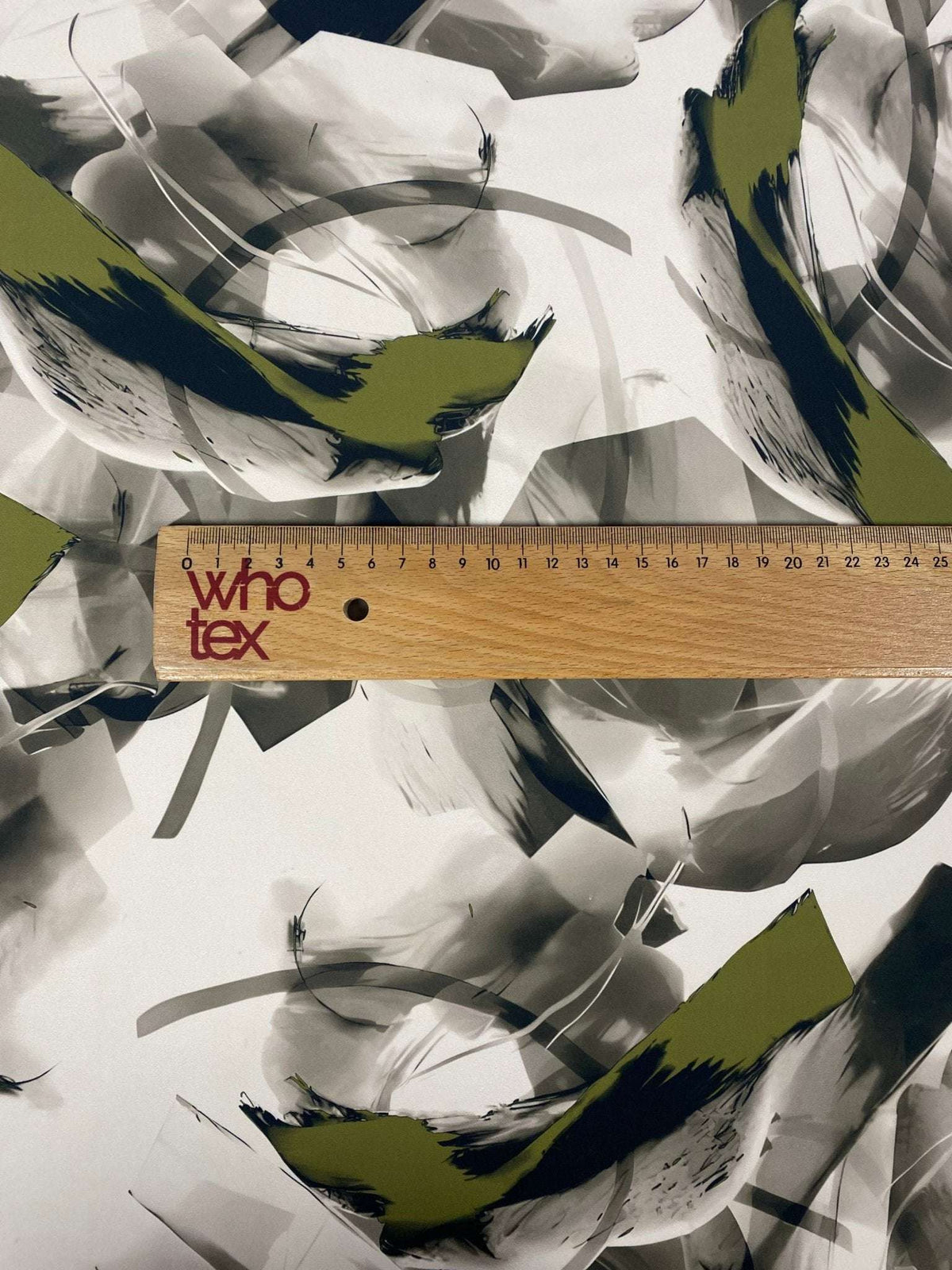 Abstract Artistic Brushstroke Fabric with green and black contemporary design, displayed with a measuring ruler for scale
