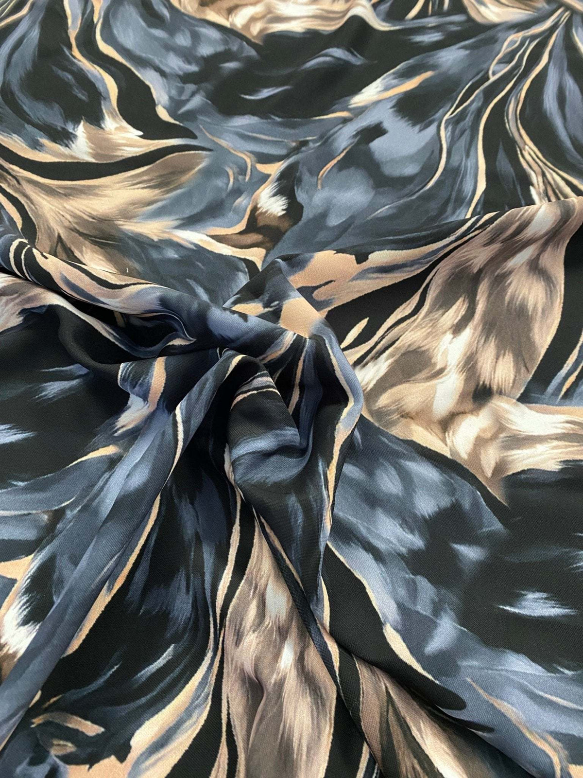 Abstract feather pattern fabric in black, beige, and blue with flowing design and 150cm width