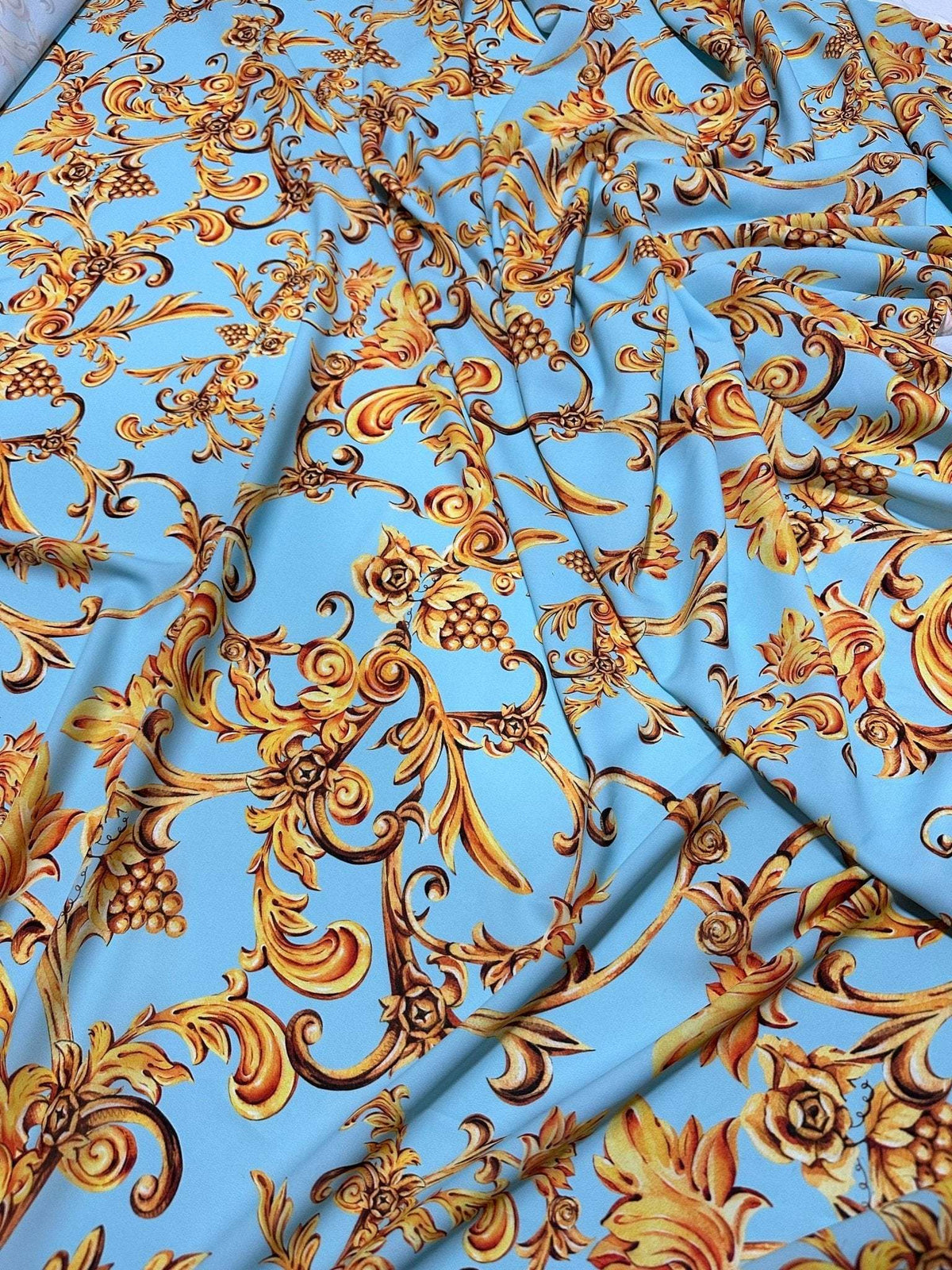 Baby blue Baroque print fabric with gold ornate floral and grapevine design, soft texture, 150cm width, ideal for sewing and home decor projects