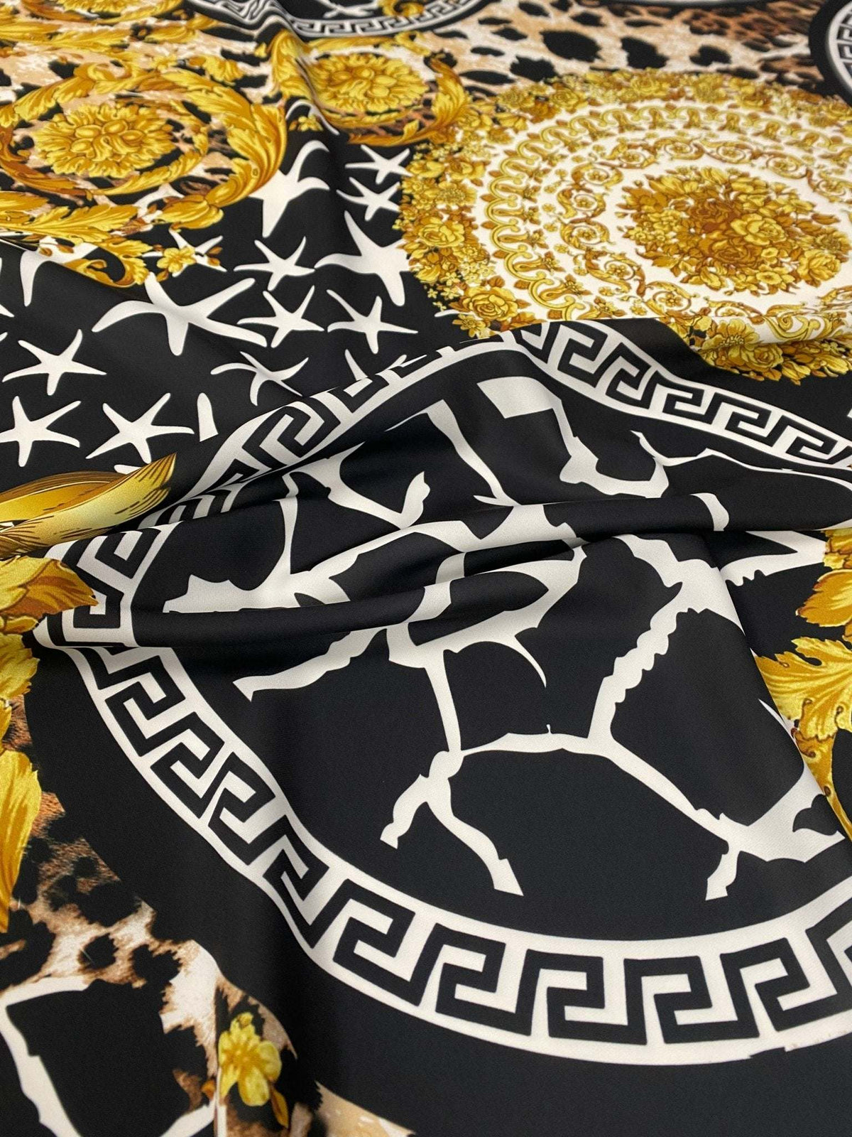 Baroque Greek key fabric with black, white, and gold ornate pattern and intricate design details
