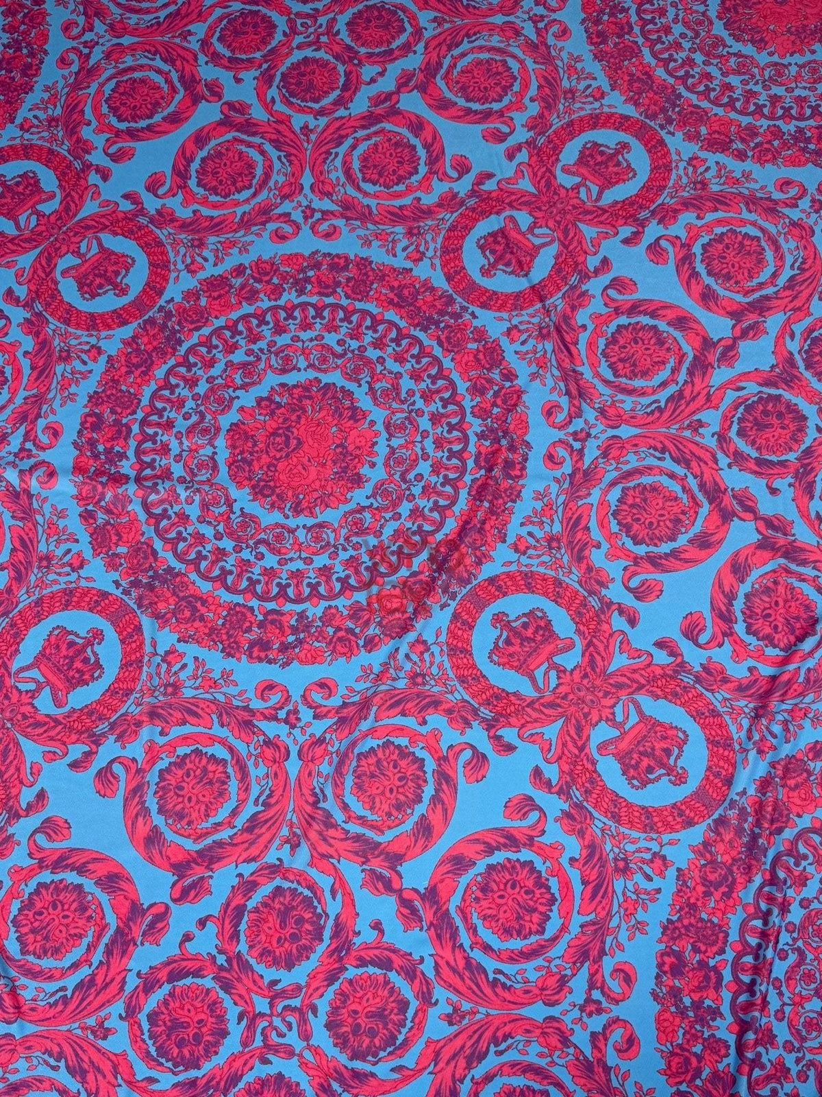 Blue fabric with intricate red baroque pattern design for upholstery and sewing projects