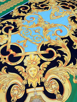 Baroque silky crepe fabric with intricate gold baroque patterns on blue and black background