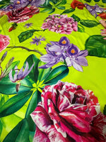 Floral neon green fabric with large pink, purple, and red rose pattern and green leaves.