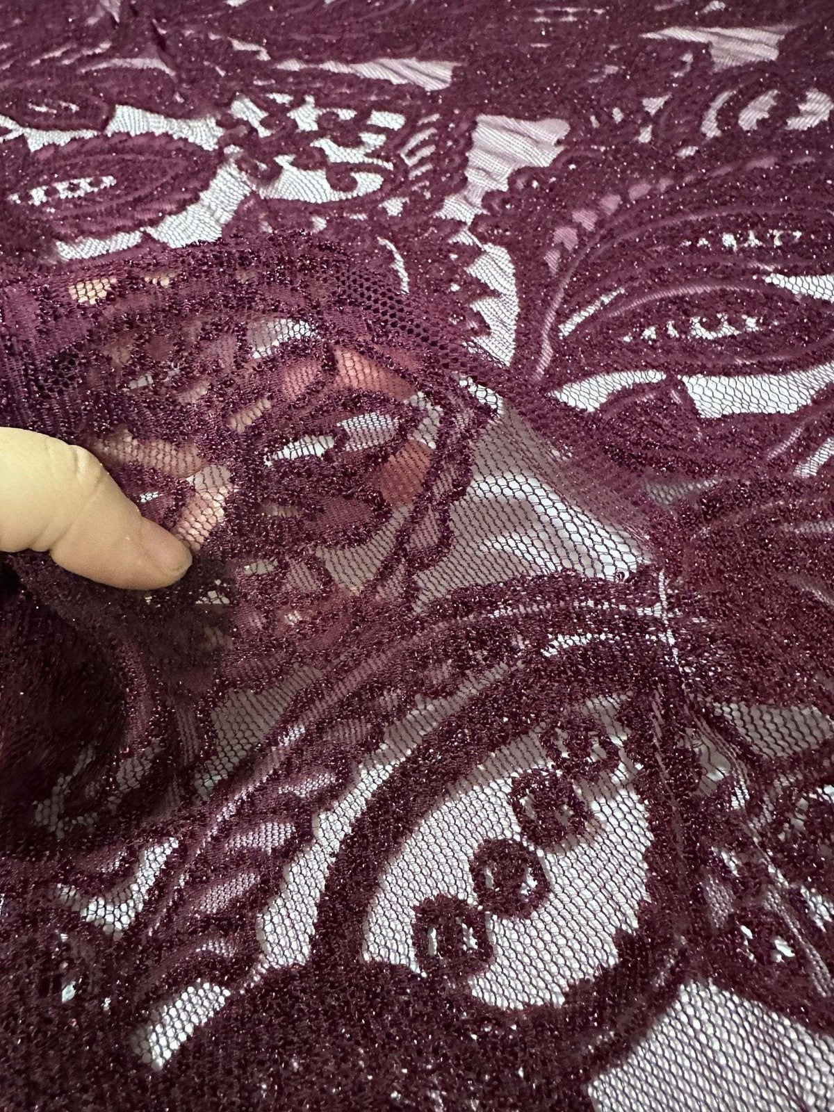 Bordeaux floral pattern lace fabric close-up showing intricate floral design and texture suitable for fashion and crafts