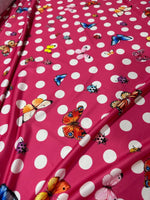 Pink fabric with white polka dots and colorful butterfly print butterfly polka dot fabric