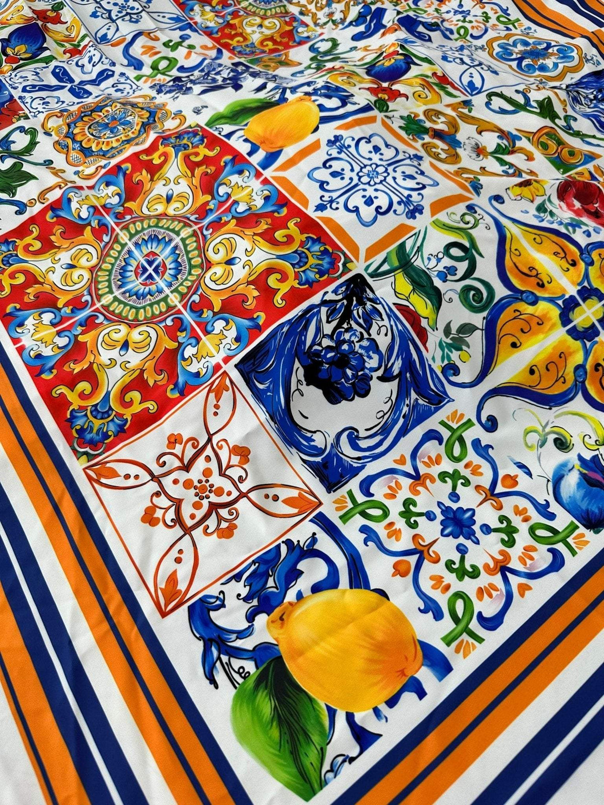 Sicilian print silky crepe fabric with vibrant multicolored tile patterns and orange tulip motifs, 150cm wide luxury material for sewing projects