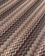 earth tone zigzag woven mesh fabric with green, brown, and beige knit pattern for versatile sewing projects