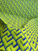 Neon green Greek key geometric fabric with bold pattern and modern upholstery design