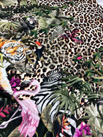 Leopard tropical leaf pattern fabric with tiger, flamingo, zebra, toucan, and lush greenery on a leopard print background
