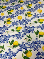 Limon Design Upholstery Fabric with vibrant yellow lemon and blue floral print on white background for home décor upholstery projects