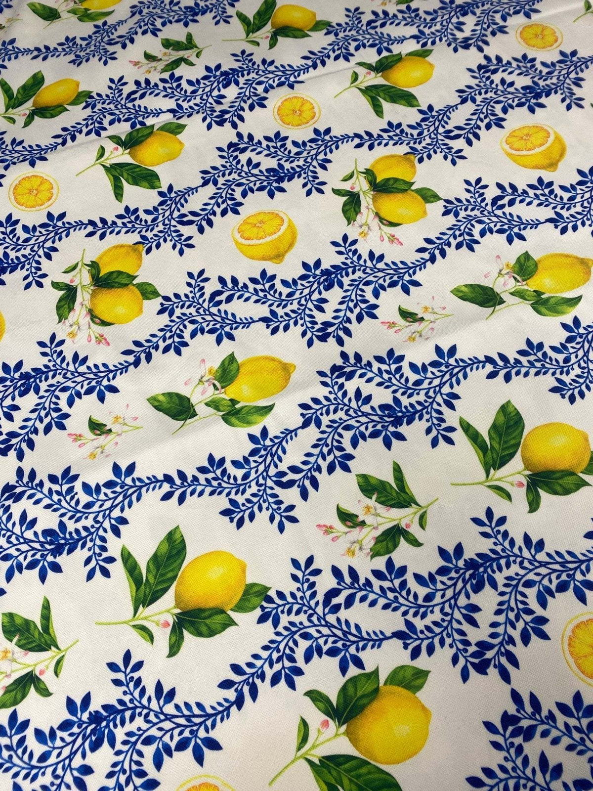 Limon Design Upholstery Fabric with vibrant yellow lemon and blue floral print on white background for home décor upholstery projects