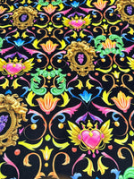 Vibrant black fabric with colorful baroque floral and heart pattern design