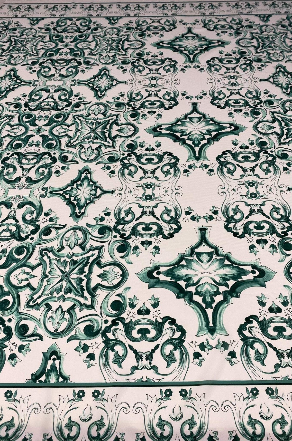 Green and white Majolica pattern fabric with intricate elegant swirl designs for home decor and upholstery projects