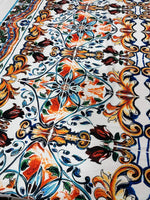 Close-up of colorful Majolica Pattern Fabric with intricate floral and ornamental designs, ideal for upholstery and home decor projects.