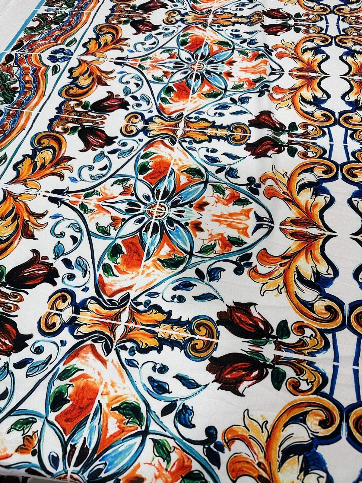 Close-up of colorful Majolica Pattern Fabric with intricate floral and ornamental designs, ideal for upholstery and home decor projects.