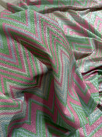Green and pink zigzag knit lurex fabric with shimmering lightweight texture for fashion and costume projects