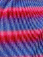 Close-up of pleated power mesh fabric with shiny threads in red and blue horizontal stripes
