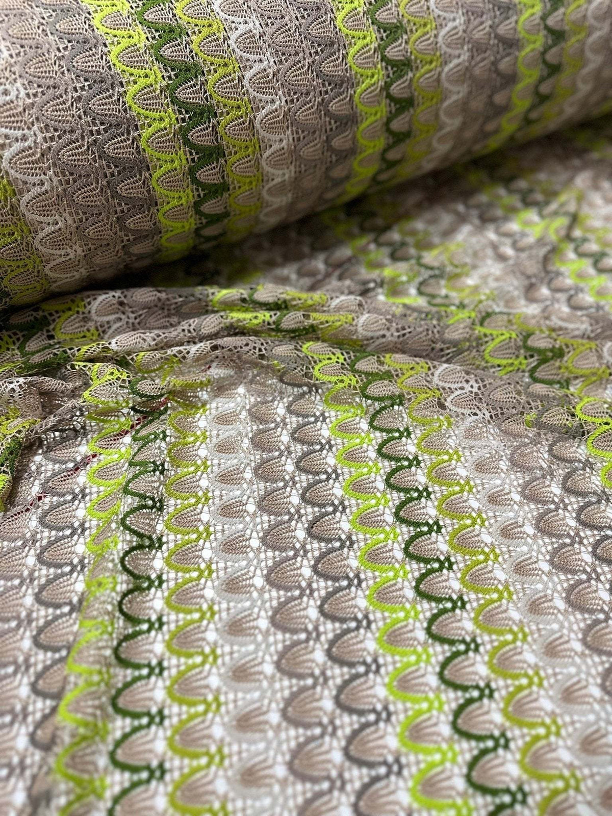 Beige green zigzag knit jersey mesh fabric with soft stretchy texture for clothing and crafts