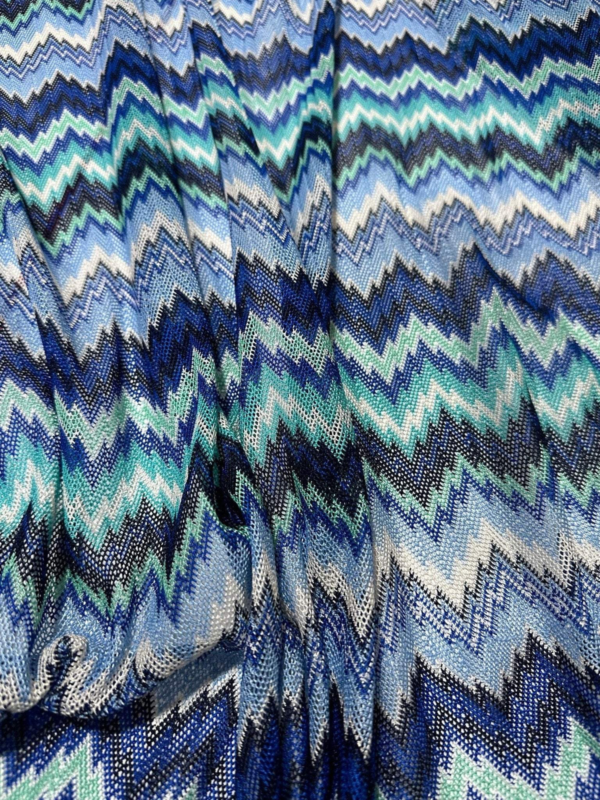 Zigzag knitted mesh fabric with blue and white chevron pattern, soft stretch knit for clothing projects