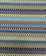 Zigzag pattern mesh fabric in yellow and blue with a wavy textured design for crafting and fashion projects