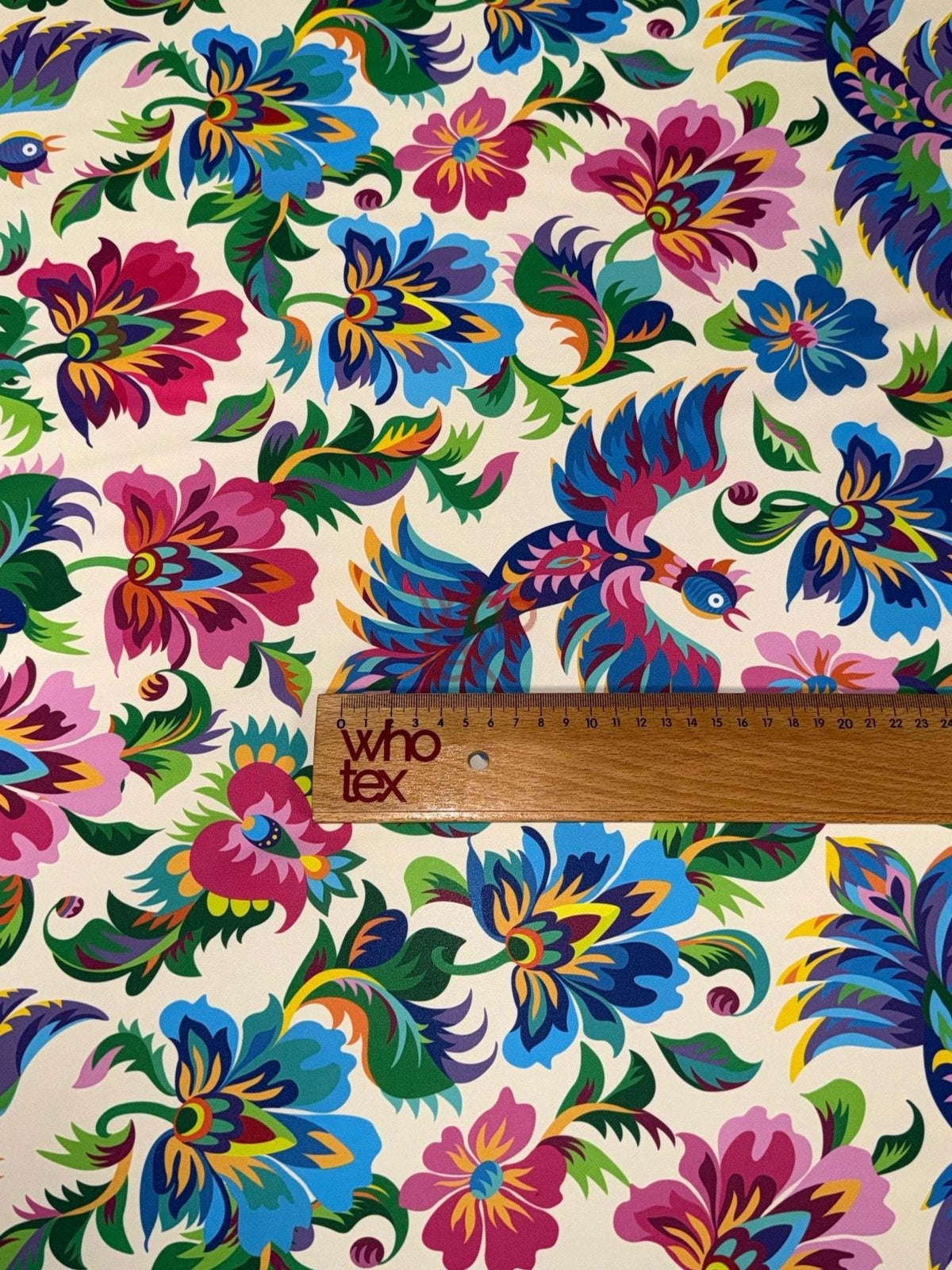 Vibrant Otomi Bird Fabric with multicolor Mexican floral pattern and traditional Otomi design featuring birds and flowers on cream background with ruler for scale.
