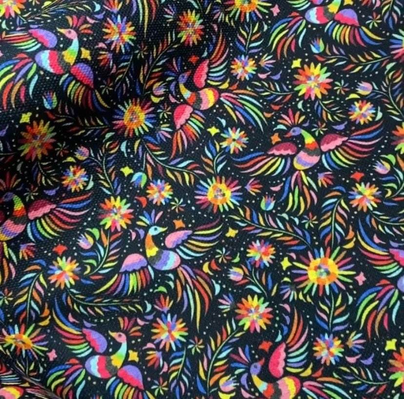 Otomi pattern upholstery fabric with colorful birds and floral designs on black background