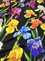 Floral crepe fabric with vibrant multicolor flowers on a black background, lightweight and soft for sewing projects