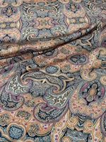 Black and orange paisley patterned fabric with intricate decorative design and 150cm width