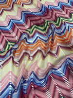 Pastel multicolor chevron mesh fabric with zigzag knit pattern in vibrant green, blue, pink, orange, and yellow tones.