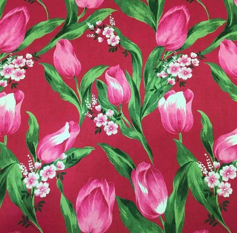 Pink tulip fabric with vibrant red background and green leaves floral pattern
