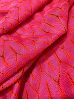 Pink and white chevron knit jersey fabric with a stylish zigzag pattern and soft texture