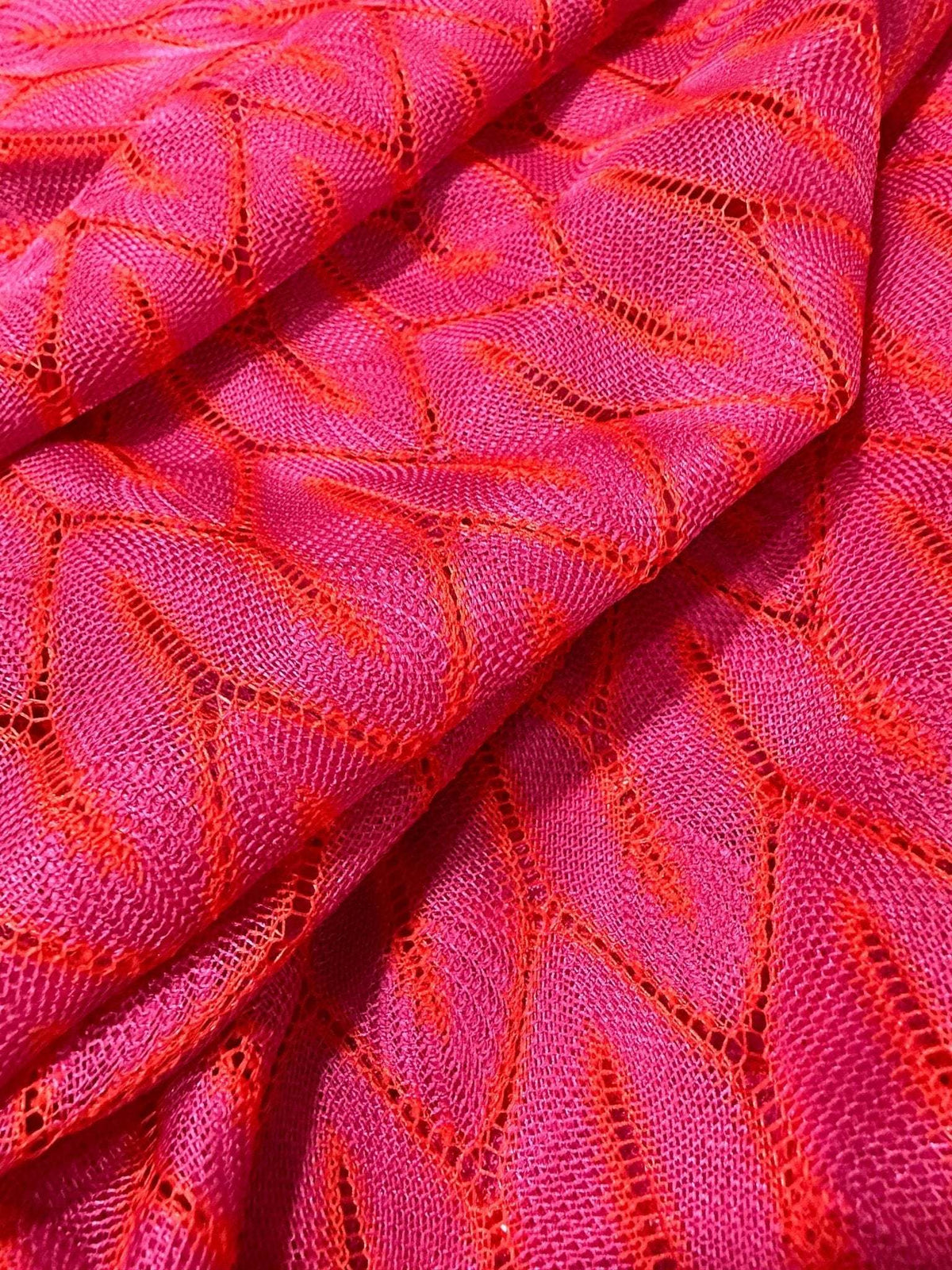 Pink and white chevron knit jersey fabric with a stylish zigzag pattern and soft texture
