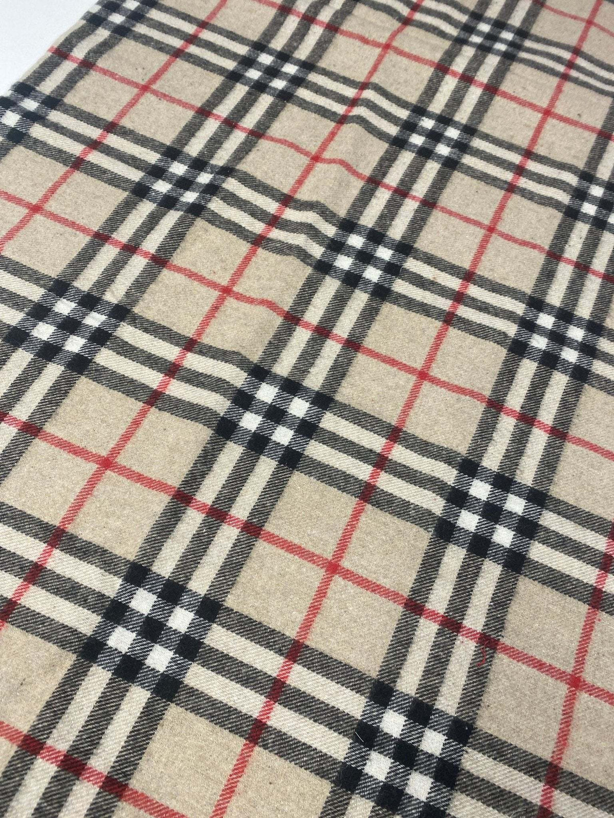 Plaid woolen fabric with beige base and black, white, and red check pattern suitable for jackets and coats
