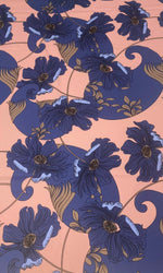 Retro style blue floral print fabric on peach background with vintage design elements