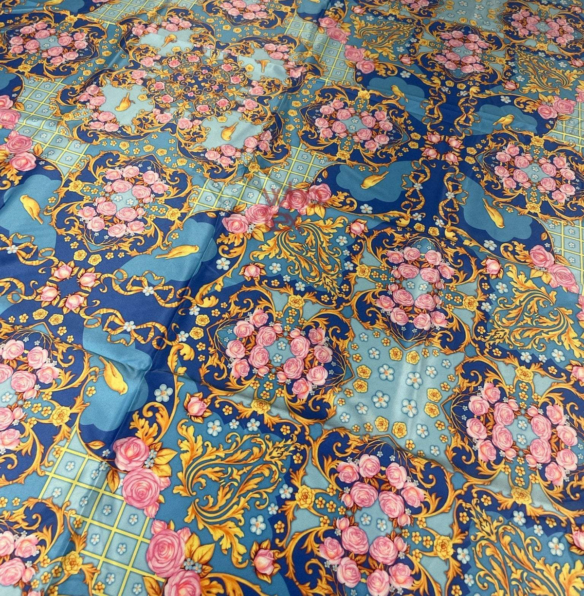Royal blue ornate fabric with roses, birds, and gold scroll patterns