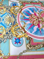 Baroque chain pattern fabric with ornate gold scrolls, compass motifs, and pastel blue and pink background