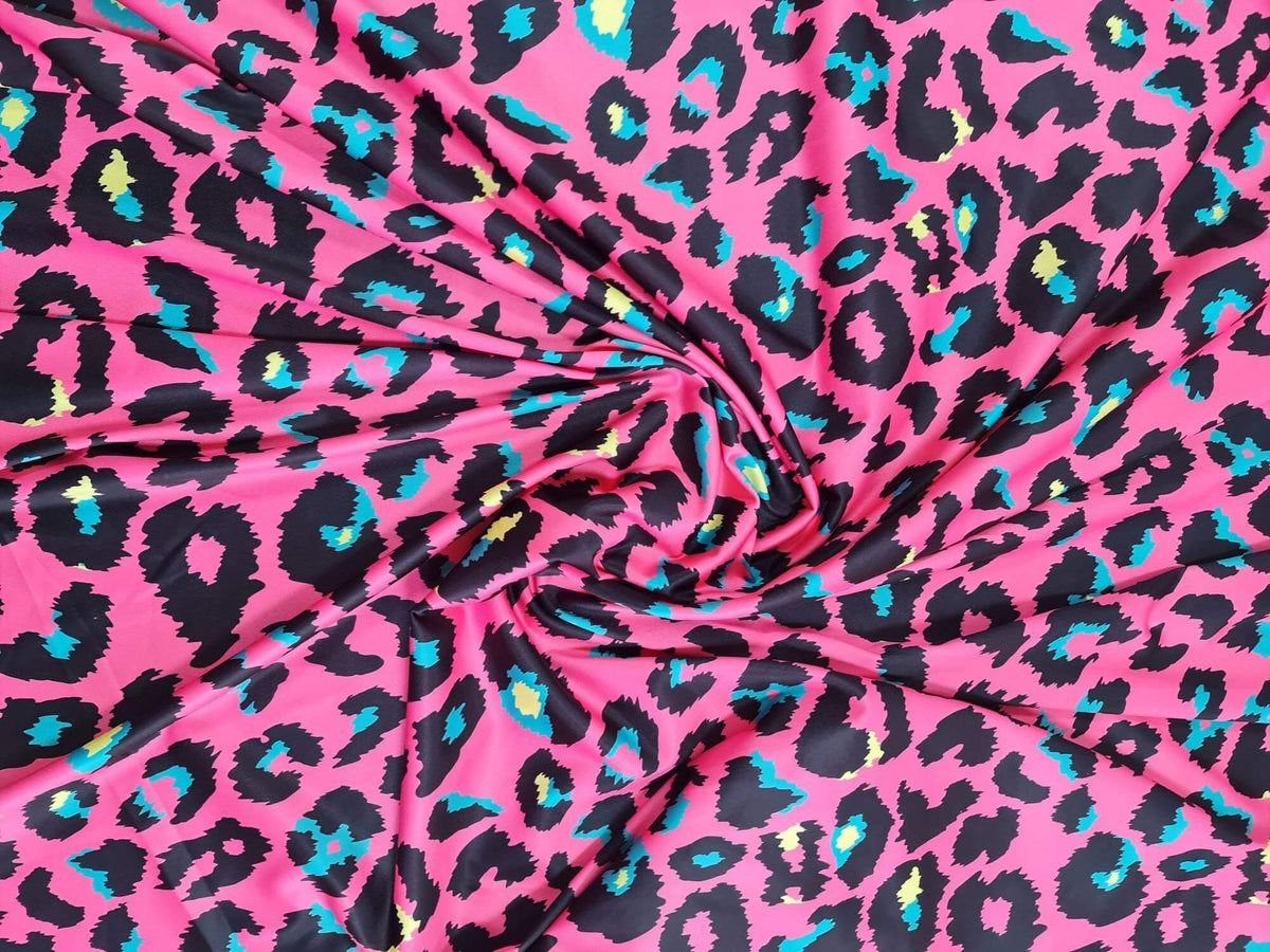 Sugar pink leopard print fabric with vibrant blue and yellow accents, 150cm wide, suitable for clothing and crafts