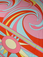 Retro psychedelic swirl and sun print fabric in pink, red, blue, and yellow colors with vibrant retro patterns.