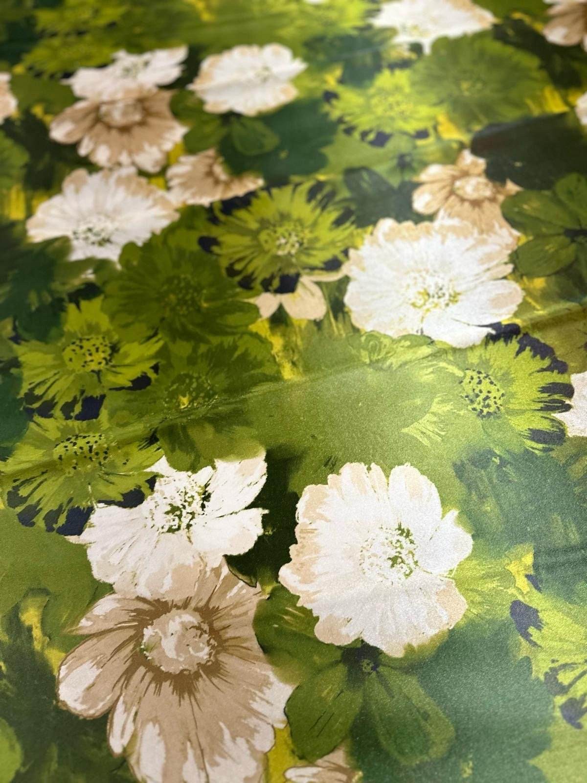 close-up of watercolor floral fabric with green leaves and white flowers