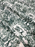 Green and white wild forest animal print fabric with detailed nature-inspired design for sewing and home decor projects