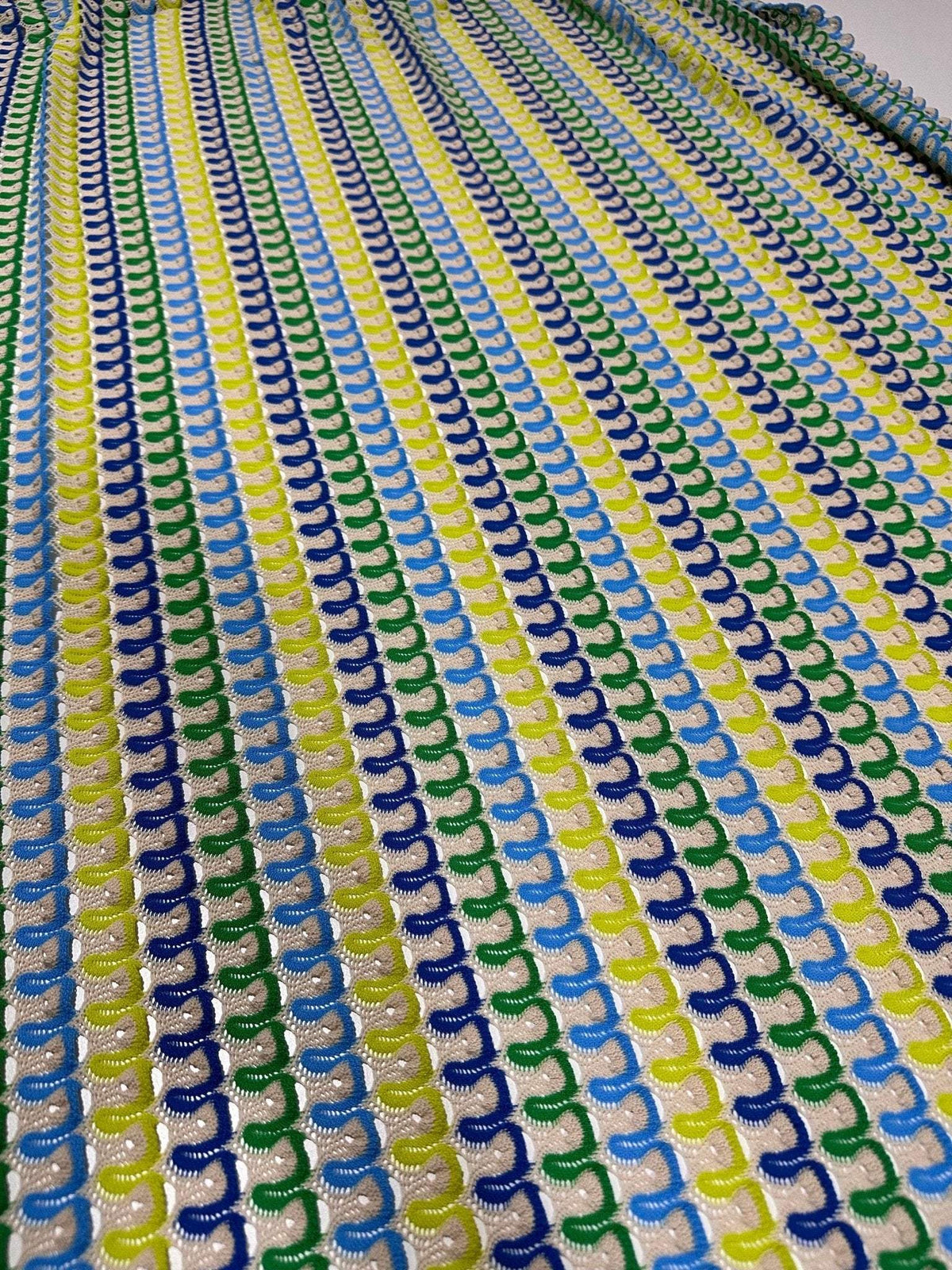 Luxury zigzag knit jersey fabric with blue, yellow, and green chevron pattern in a soft, stretchy texture