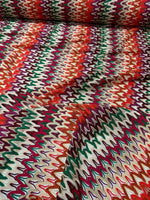 Multicolor zigzag knit jersey fabric with vibrant chevron pattern and soft texture.